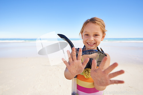 Image of Girl, portrait and hands for goggles at beach, swimming and equipment for snorkeling on holiday. Female person, child and happy on tropical vacation in outdoors, sand and blue sky for mockup space