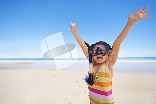 Image of Girl, happy and goggles for celebration at beach, energy and equipment for snorkeling on holiday. Female person, child and victory on tropical vacation in outdoor, sand and blue sky for mockup space