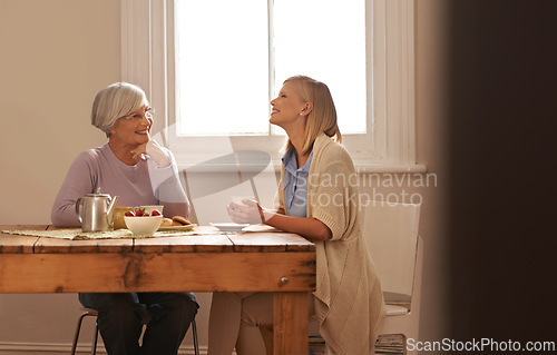 Image of Family, happy woman and senior mother drinking coffee at breakfast, bonding and smile. Elderly mom, adult and tea cup at table for conversation, love and daughter eating cookies at home together