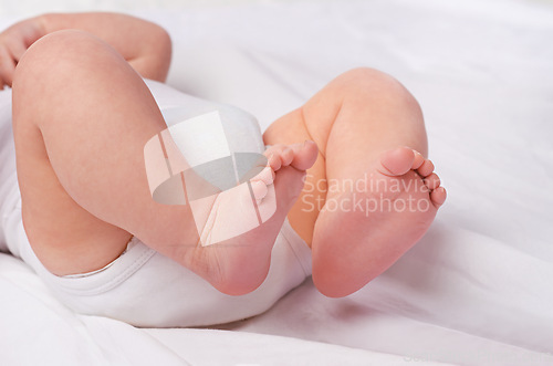 Image of Closeup, newborn baby or feet for relax, bed and nap for healthy childhood, care and development. Bare foot, leg and toes of young child for calm, rest and sleeping in peaceful nursery for dreaming