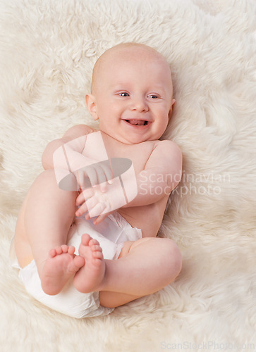 Image of Baby, cute and laugh in bedroom, blanket and playtime in diaper for child development in happiness. Infant, kid and wellness for newborn, adorable and rug in house for home and toddler fun