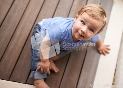 Image of Floor, above or portrait of baby in home for fun playing, happiness or learning alone on porch. Relax, boy or face of a toddler on ground with smile for child development or growth in house top view