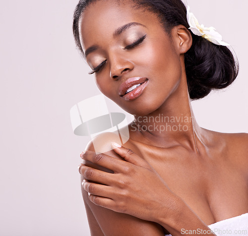 Image of Woman, face and orchid for skincare in studio with beauty, natural glow and self care with confidence. Model, african person or flower for cosmetology, facial treatment or makeup on white background