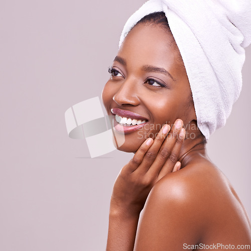 Image of Black woman, mockup and hair towel in studio with skincare, wellness or beauty on purple background. Makeup, cleaning or hands on face of happy female model touching soft, skin or cosmetic results