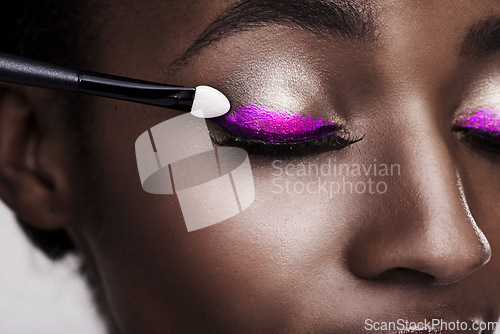 Image of Closeup of black woman, lashes and brush for eyeshadow with makeup, beauty and color on pink background. Skin glow, cosmetic product and tools for cosmetology, shimmer or glitter with shine in studio