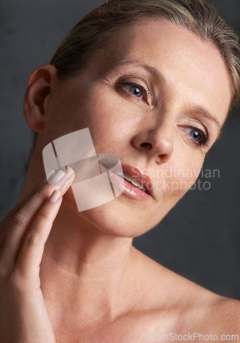 Image of Face, skincare and memory with mature woman in studio on gray background for aesthetic wellness. Beauty, facial and thinking with natural skin person at spa for antiaging cosmetics or treatment