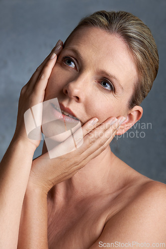 Image of Face, skincare and thinking with mature woman in studio on gray background for aesthetic wellness. Beauty, relax and hygiene with natural skin person at spa for antiaging cosmetics or treatment