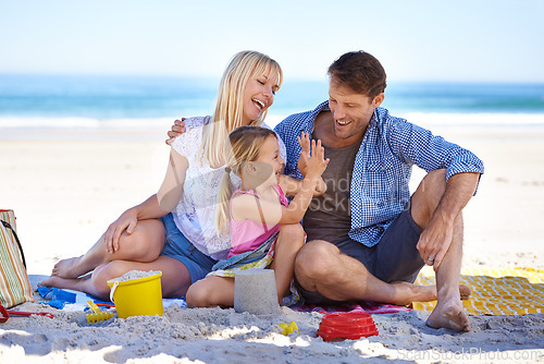 Image of Family, beach and young girl on vacation, seaside and ocean with sand castle for bonding time. Holiday, overseas and summer season with parents, daughter and sunshine for happy memories in Hawaii
