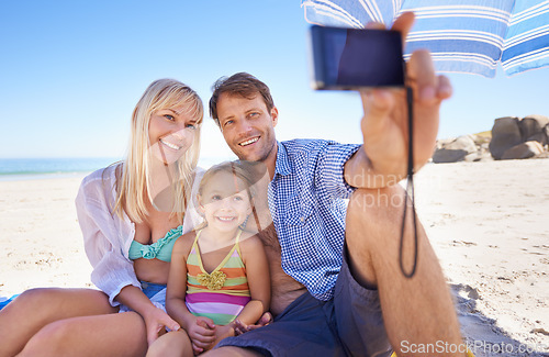 Image of Happy family, beach and relax with selfie for picture, moment or photography in outdoor nature. Mother, father and child with smile for photo, camera or bonding memory together on the ocean coast