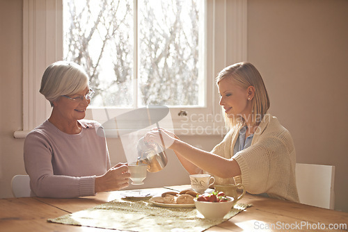 Image of Happy, grandmother and woman with tea in home for brunch, bonding or visit in retirement. Senior, grandma and girl on coffee break with food, conversation and pouring liquid with steam in morning