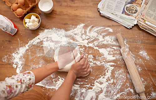 Image of Chef, hands and recipe for dough on table, baking in kitchen and above process in bakery. Person, prepare and press bread with flour for meal prep and learning information from guide in book