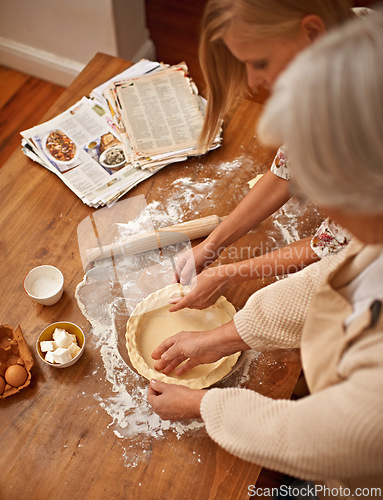 Image of Above, people and hands baking with dough on table in kitchen and helping process in bakery. Family, prepare and press pastry in dish with flour, meal prep and work with information guide from book