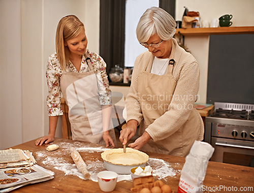 Image of Mature, mother and baking with woman in kitchen, helping and meal prep together for dinner. Senior, mom and girl in home learning about family recipe with flour, dough or cooking a pie on table