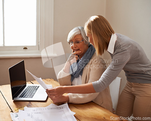 Image of Granddaughter, grandmother and help with laptop for budget, finance and technology with advice and assistance. Women pay bills online, life insurance or tax paperwork with retirement and discussion