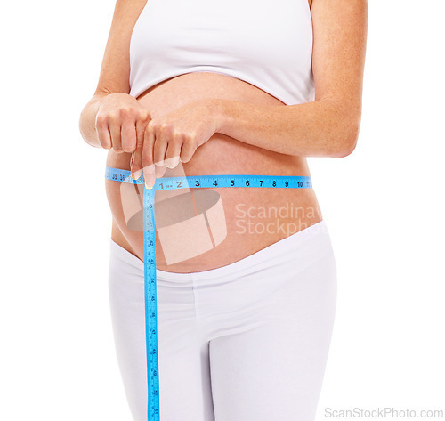 Image of Woman, hands and pregnant with measure for growth in studio on white background for wellness and health. Closeup, female person and mother on maternity with pregnancy, stomach and future family