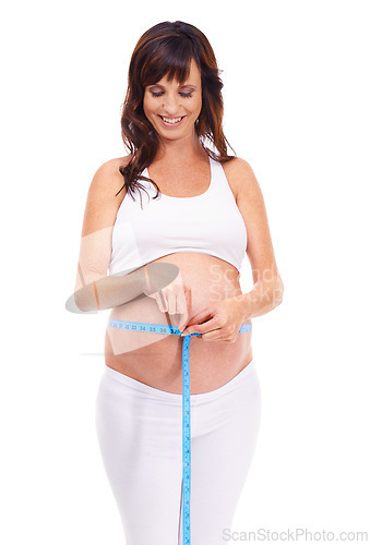 Image of Woman, smile and pregnant with measure for growth in studio on white background for, happiness, wellness and health. Maternity, mother and isolated with pregnancy for childbirth and future family.