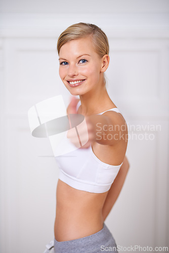 Image of Happy woman, portrait and fitness with thumbs up for workout, exercise or training at home. Face of female person or yogi with smile, like emoji or yes sign for good job, success or winning at house