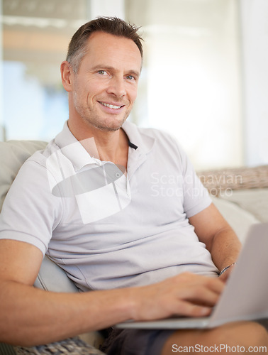 Image of Man, laptop and portrait on patio in home, chair and typing with search for movies on website. Person, computer and relax on couch, scroll and happy for streaming subscription on holiday at apartment