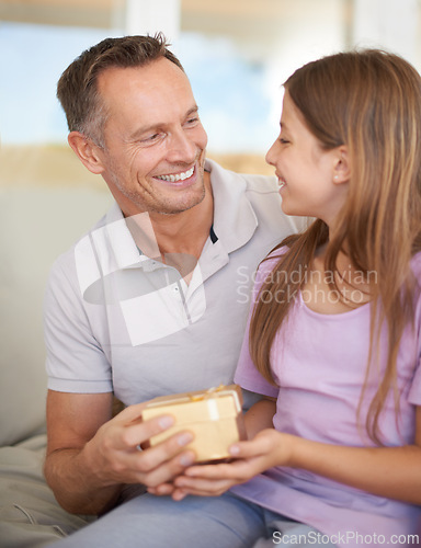 Image of Smile, father and daughter on sofa with gift box for birthday, achievement and celebration in family home. Giving, happy girl child and dad on couch for present, gratitude and surprise in living room