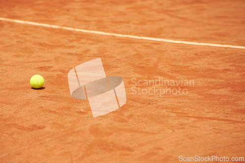 Image of Tennis ball, clay court and space for fitness, sports or training outdoor in summer with no people. Exercise, health and wellness with mockup on ground of empty stadium or venue for competition