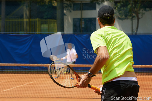 Image of Fitness, health and tennis with man on court for competition, game or match in summer from back. Coaching, sports or training with athlete person and rival outdoor on clay for workout or hobby