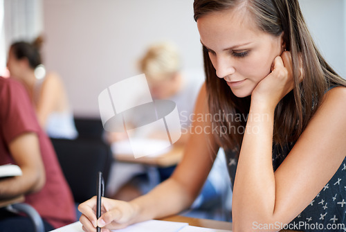 Image of University, student and woman writing on notebook in academy for education with scholarship. Female person, exam and classroom for learning, knowledge and information from research for girl on desk
