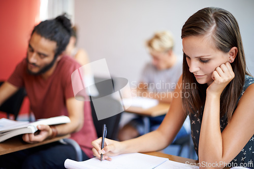 Image of Woman, writing and class in college, learning and knowledge on campus for education. Student, female person and notes for information in book, planning and research for studying or revision for exams