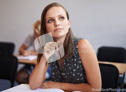 Image of Woman, student and thinking with book in classroom for learning, studying or education at university. Female person or academic learner in wonder for assignment, ambition or literature exam at campus