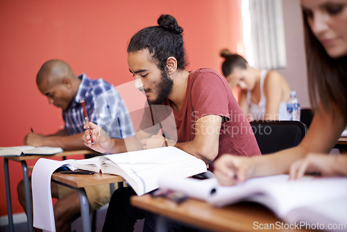 Image of Group, students and classroom with books for learning, info and solution with thinking, studying and ideas. Men, women and education for exam with notes, pen and reading for development at university