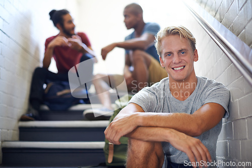 Image of Portrait, student and man with friends on stairs of college with backpacks, hangout and happiness. Steps, male person and relax with smile in university with people, gen z and scholarship for guy