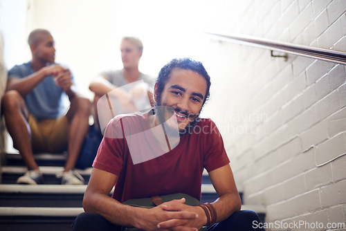 Image of Student, classmates and happy with portrait on staircase for conversation at recess, break and campus. Diverse people, talking and relax on steps in hallway at university between lecture or class