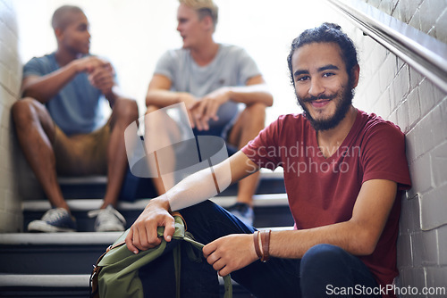 Image of Portrait, stairs and student with smile, backpack and together with classmates as friends for conversation. University, school and man in course with scholarship, campus and people relax on steps