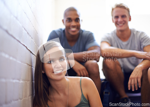 Image of Portrait, students and smile in college stairs, relaxing or resting and happiness for break. People, men and woman in university diversity or group, friends and sitting on campus before class
