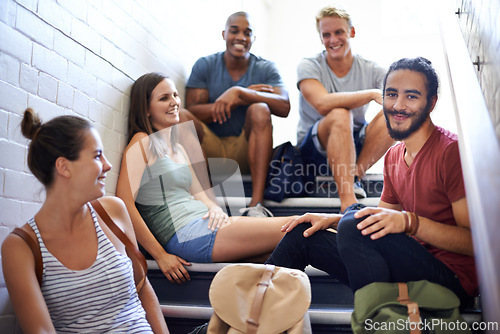 Image of University, steps and students with happiness, friends and smile together, classmates and conversation. Campus, women and men in course for education with scholarship, relax and people on stairs