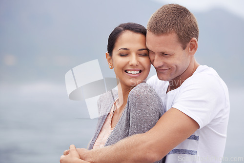 Image of Happy couple, hug and peace with travel to beach, vacation in Mexico for honeymoon and marriage with love. Support, commitment and trust in relationship with ocean, romantic adventure and bonding