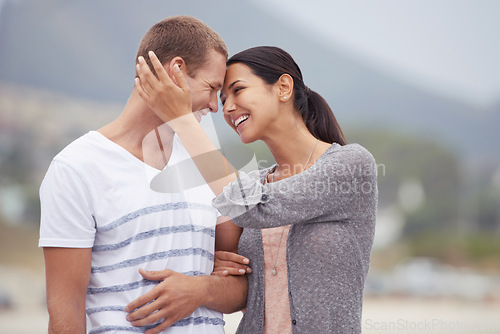 Image of Happy couple, hug and walk on the beach for travel, forehead touch and together outdoor. Romantic adventure, love and affection for bonding, support and trust with commitment on holiday in Mexico