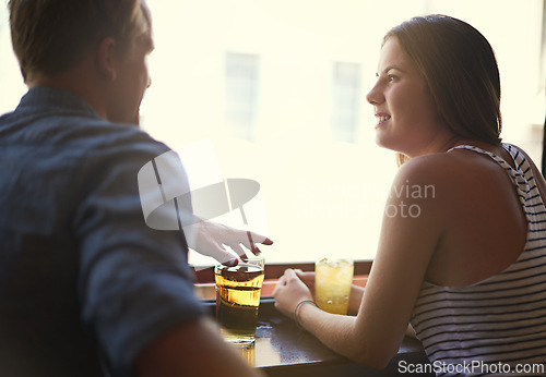 Image of Talk, happy couple and drinking beer in pub, relax and leisure together in restaurant with alcohol. Smile, man and woman in conversation at bar for connection, relationship or bonding on date at club