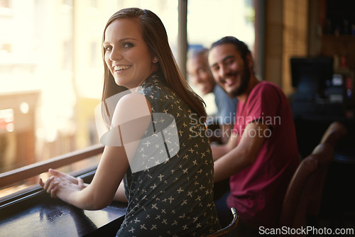 Image of Friends, woman and portrait at cafe, smile and relax indoor for fun and bonding in sunset to diverse. People, bistro and sitting for social, guys and joy together and laughing for fun and weekend.