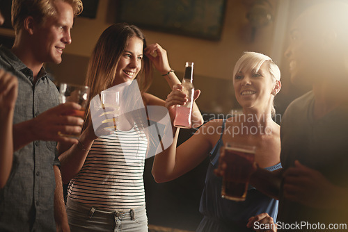 Image of Nightclub, friends and people cheers with alcohol, cocktail and drinks for fun, social gathering and toast. Happy, relax and men and women with beer together for weekend, celebration and holiday