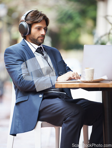 Image of Businessman, laptop and headphone working in cafe, internet and social media for online meeting and remote work. Professional, technology and lunch break with coffee and google it for networking idea