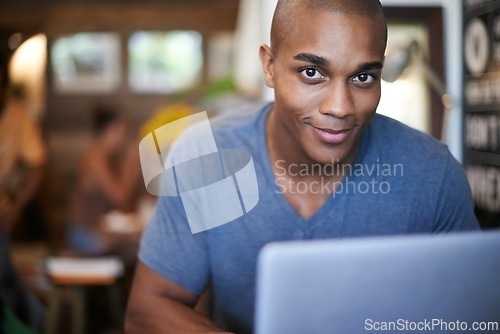 Image of African man, portrait and laptop in cafe, restaurant and coffee shop working for creative career. Male person, gen z guy and freelancer with happiness for job in research, internet and web design