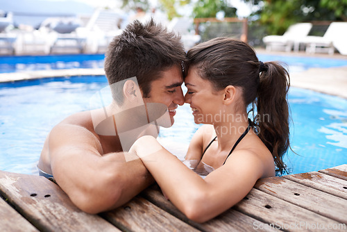 Image of Couple, pool and love with smile on holiday for kiss, date and summer to relax with forehead touch. Outdoor, relationship and vacation with happiness together in jacuzzi for affection and romance