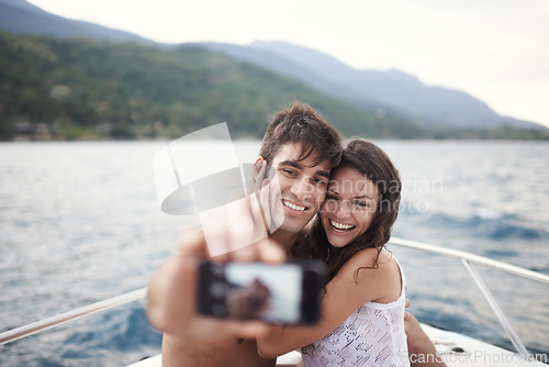 Image of Couple, vacation and selfie on boat, ocean and Bali for getaway with smile and affectionate. Man, woman and love for phone, happy and travel on yacht and summer holiday by mountain and water