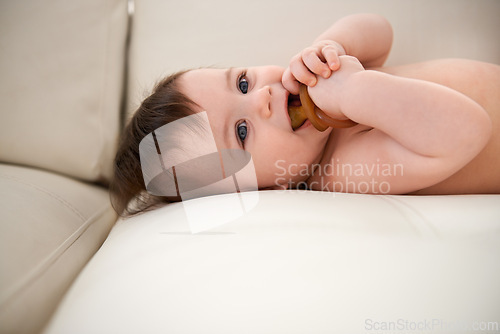 Image of Baby, cute and happy with dummy on sofa for sleep, healthy development and growth. Infant, adorable and innocent with smile, calm and pacifier on couch to relax in family home with support and love