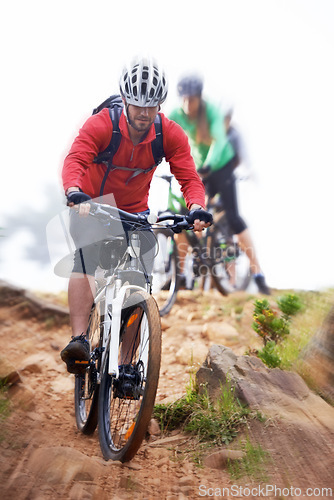 Image of Man, bicycle and cycling on dirt road for fitness, extreme sports or cardio exercise in nature. Male person, athlete or cyclist riding bike on rocky path, trail or outdoor slope with motion blur