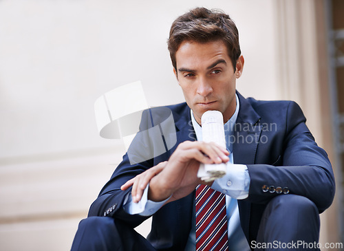 Image of Businessman, thinking and newspaper for ideas for corporate company in city as employee of business. Man, ambitious and sitting on street and thoughtful about stocks information on finance of work