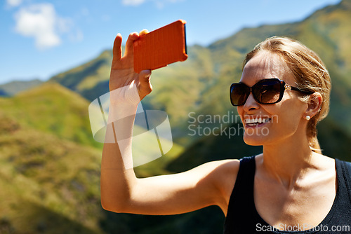 Image of Woman, photography and mountains for travel, phone and hiking or outdoor journey in nature. Happy person, hiker or tourist with picture while trekking, vacation and explore countryside in Europe