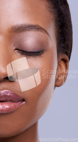 Image of Half, face and makeup, black woman with beauty and healthy glow, natural cosmetics for wellness on grey background. Eyes closed, peace and calm for dermatology, antiaging and skincare in studio