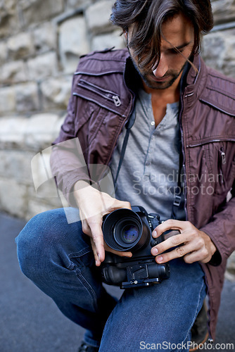 Image of Man, photographer and change camera lens for work, portfolio and outdoor shoot in London. Photography, creative, artist and freelancer at urban setting to film and street moments for profile.