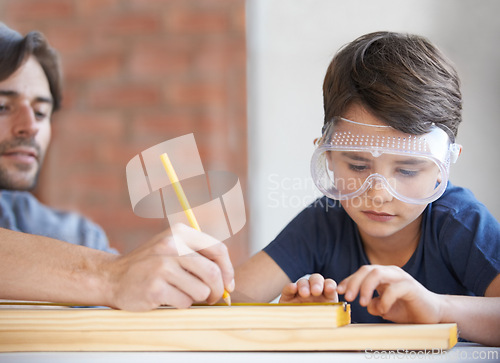 Image of Father, kid and woodwork at home for project, bonding and building with safety gear. Dad, son and carpenter for renovating, measuring and teaching with help for development of house with goggles